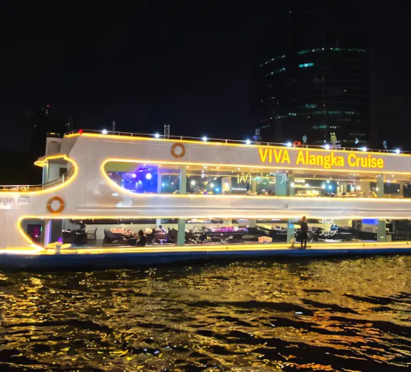 Viva Alangka Cruise illuminated on Chao Phraya River at night, Bangkok.