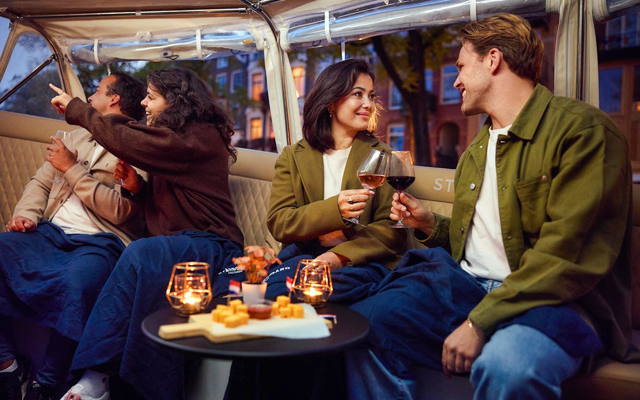 Guests enjoying wine and cheese on an evening candlelight cruise.