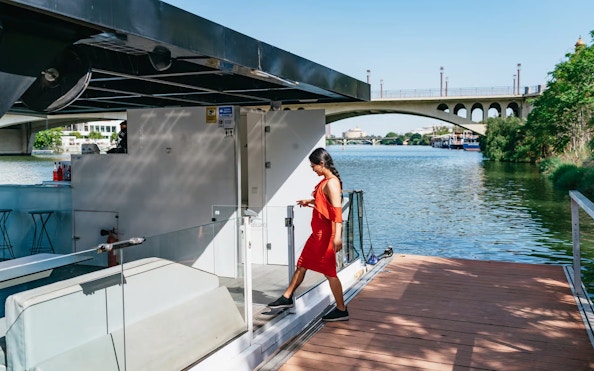 Tourist boarding Eco-Friendly Guadalquivir River Cruise in Seville, Spain.