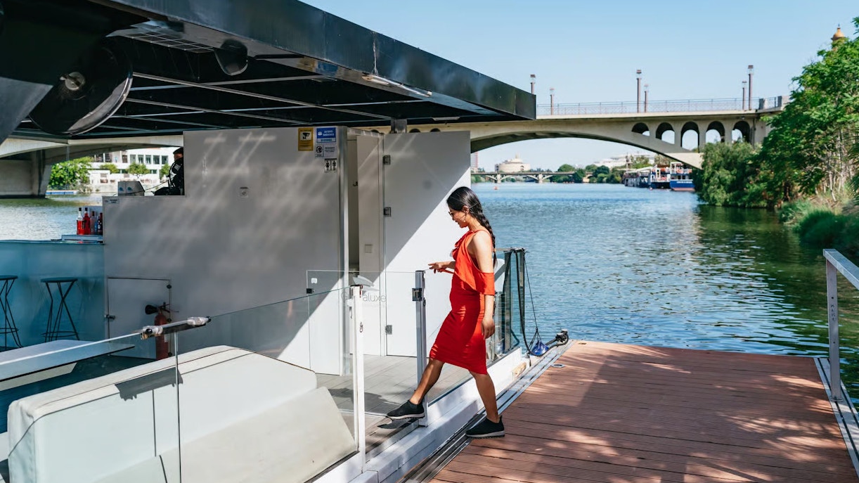 Tourist boarding Eco-Friendly Guadalquivir River Cruise in Seville, Spain.