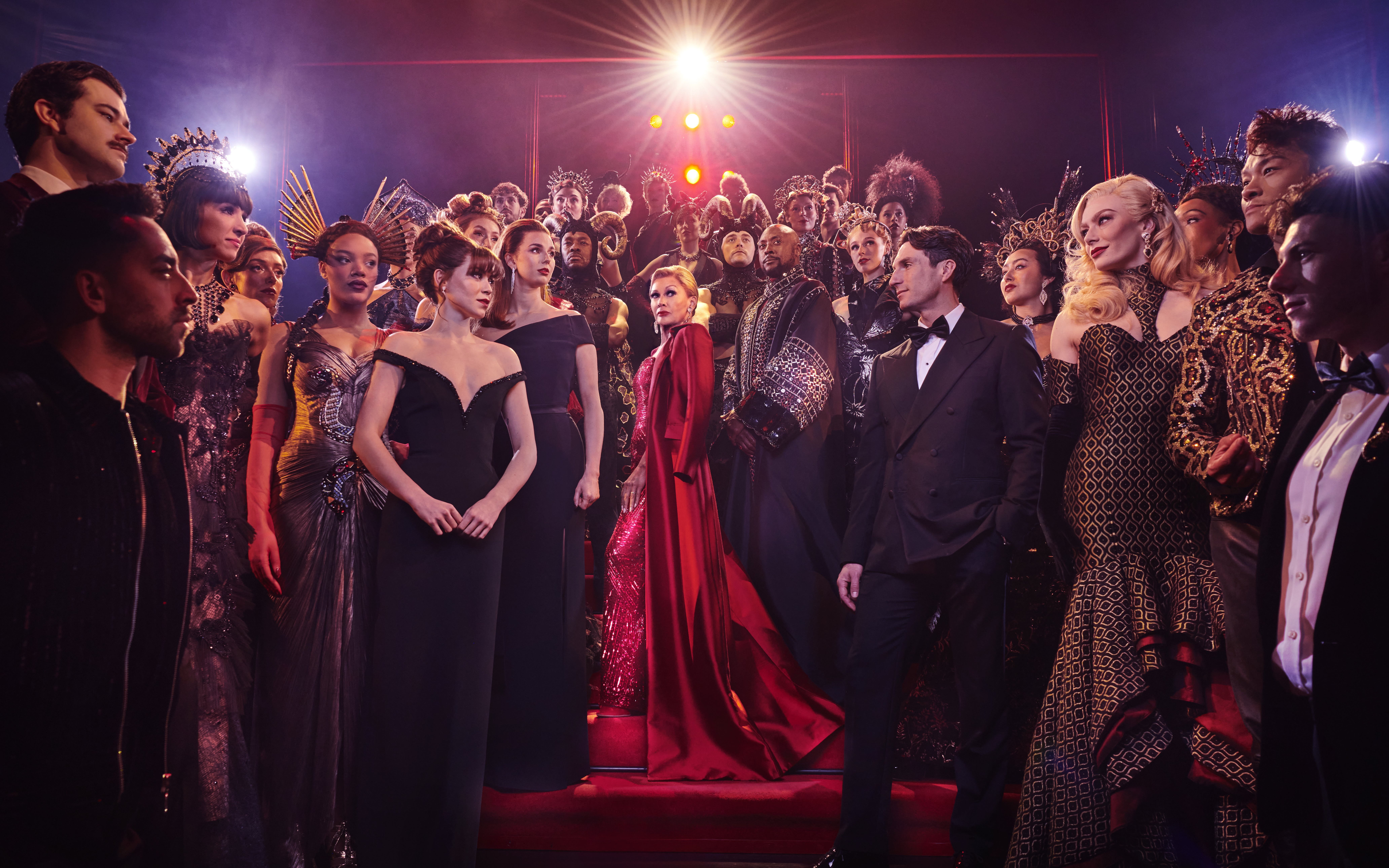 Stage performance of The Devil Wears Prada West End show with cast in elaborate costumes.