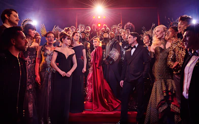 Stage performance of The Devil Wears Prada West End show with cast in elaborate costumes.
