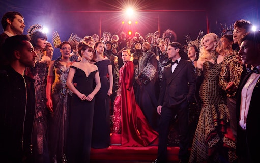 Stage performance of The Devil Wears Prada West End show with cast in elaborate costumes.