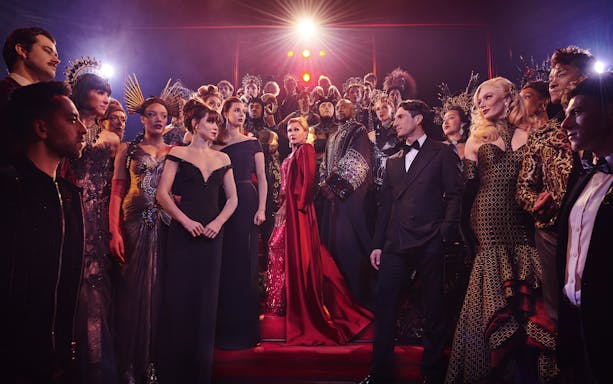 Stage performance of The Devil Wears Prada West End show with cast in elaborate costumes.