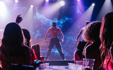 Australia's Thunder from Down Under performance on stage with audience in foreground.