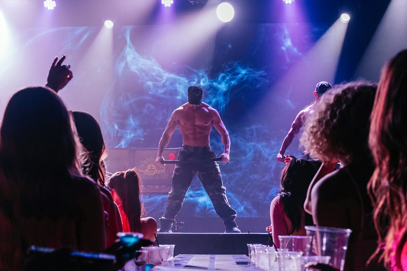 Australia's Thunder from Down Under performance on stage with audience in foreground.