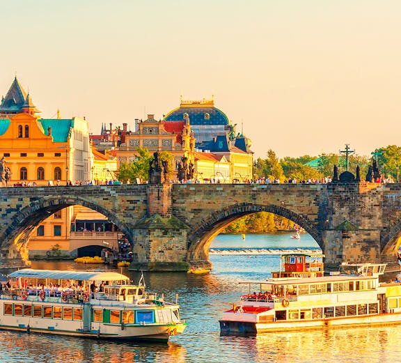 Boats on the Vltava River near Charles Bridge in Prague's Old Town.