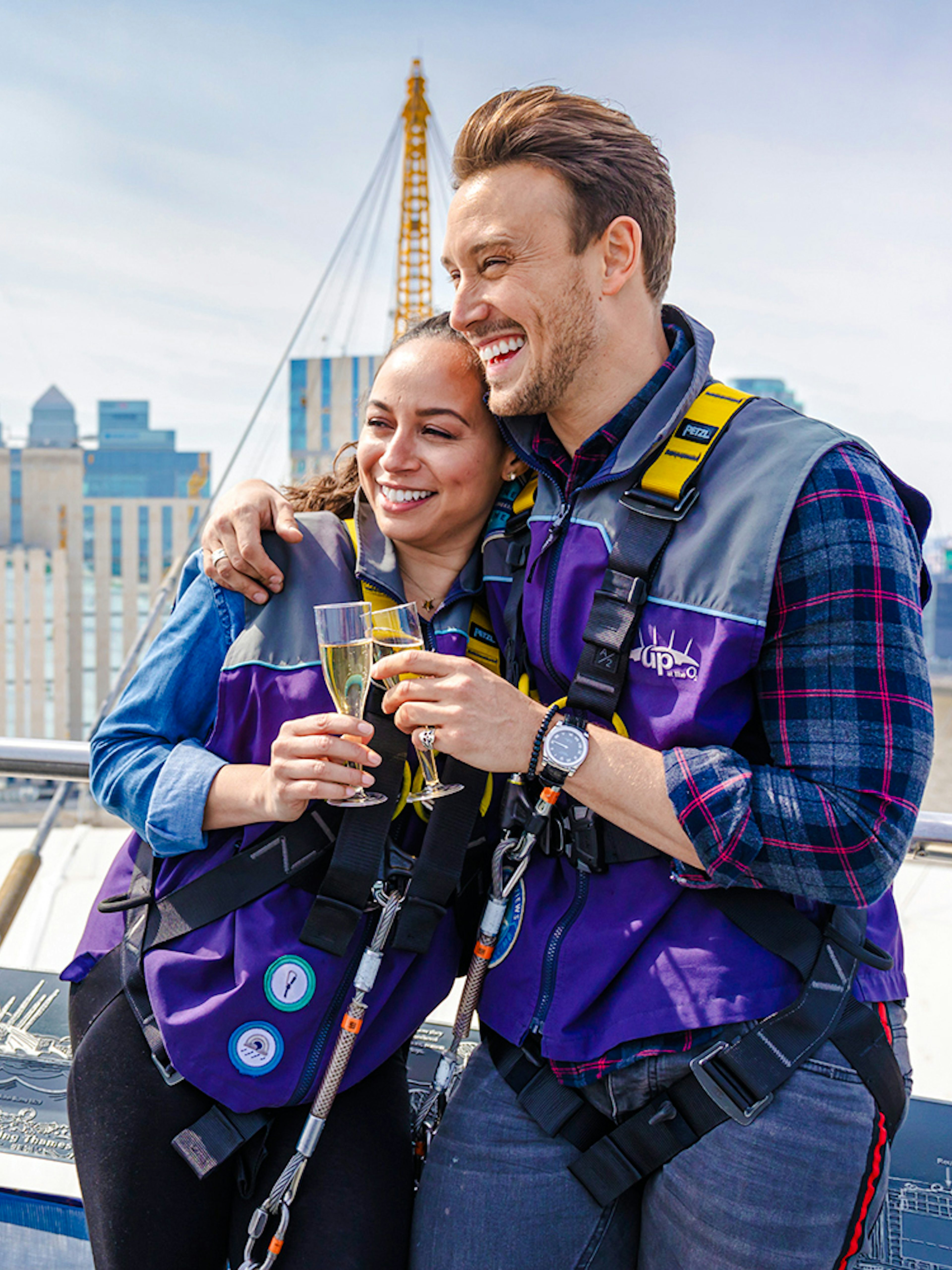 Guests enjoying drinks on Up at the O2 Celebration Climb with London skyline in background.