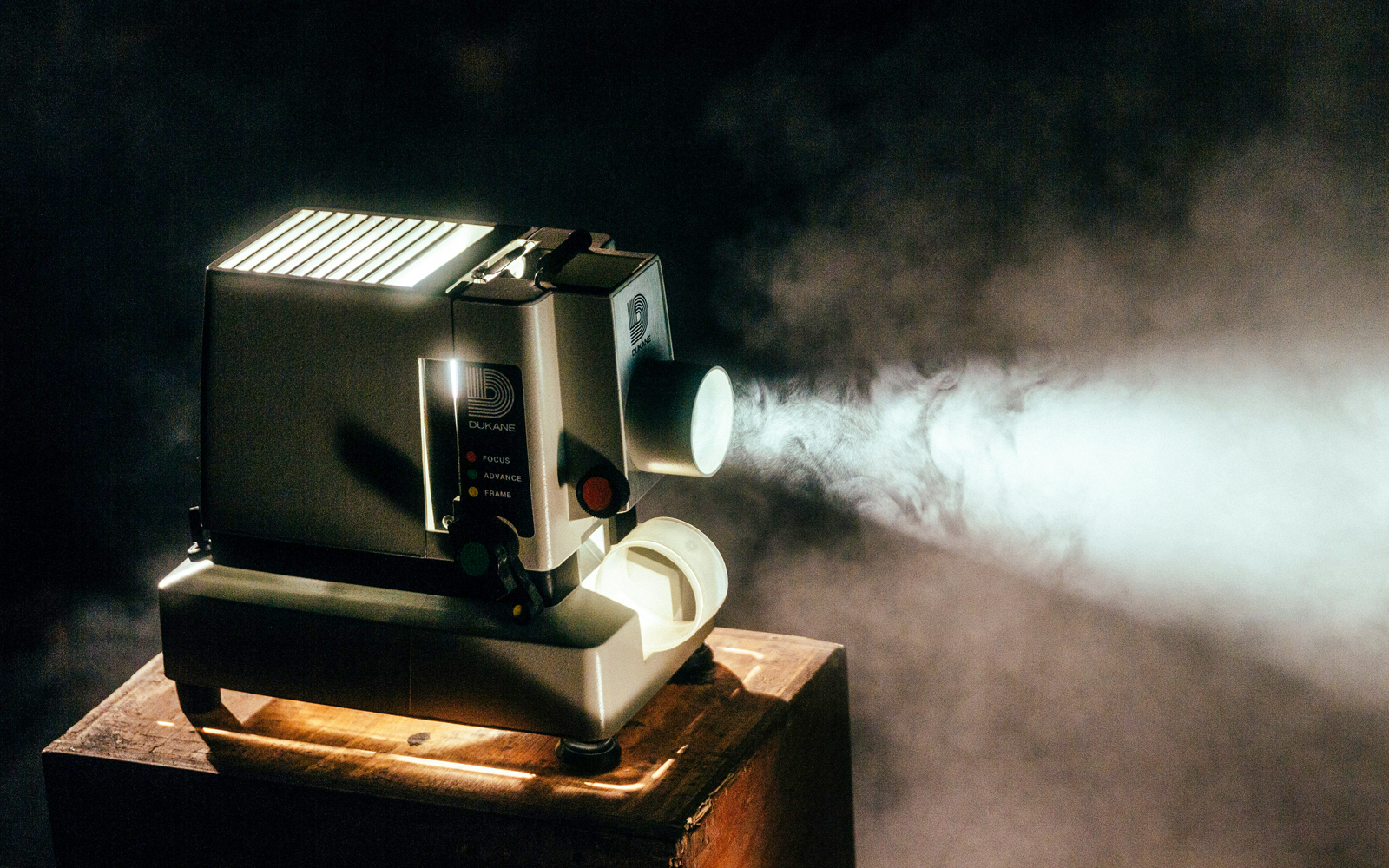 Modern projector displaying vibrant visuals in a darkened room, enhancing the immersive tour experience.