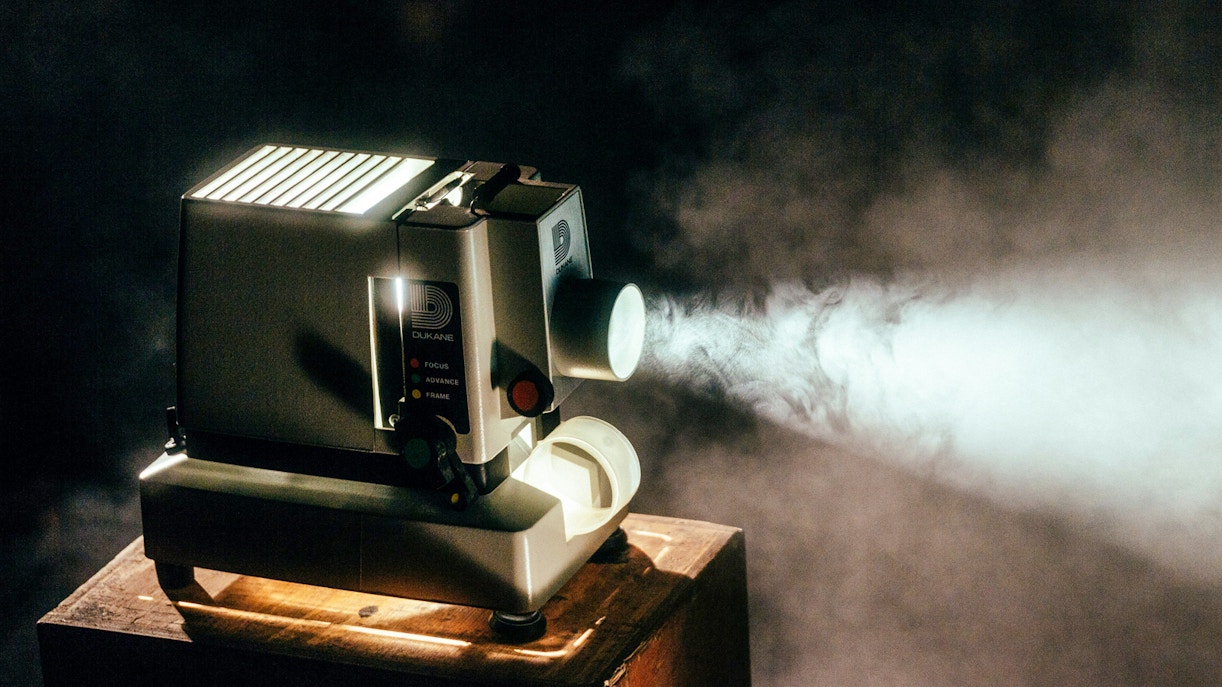 Modern projector displaying vibrant visuals in a darkened room, enhancing the immersive tour experience.