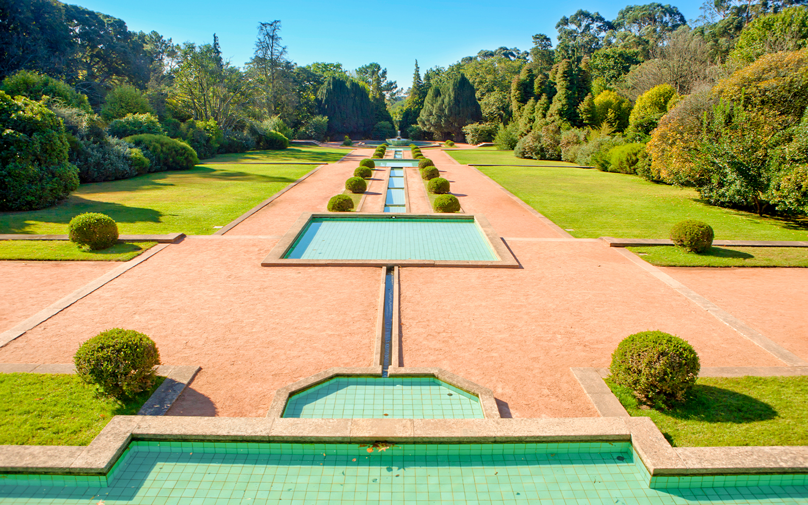 Serralves garden with geometric water features and manicured hedges in Porto, Portugal.