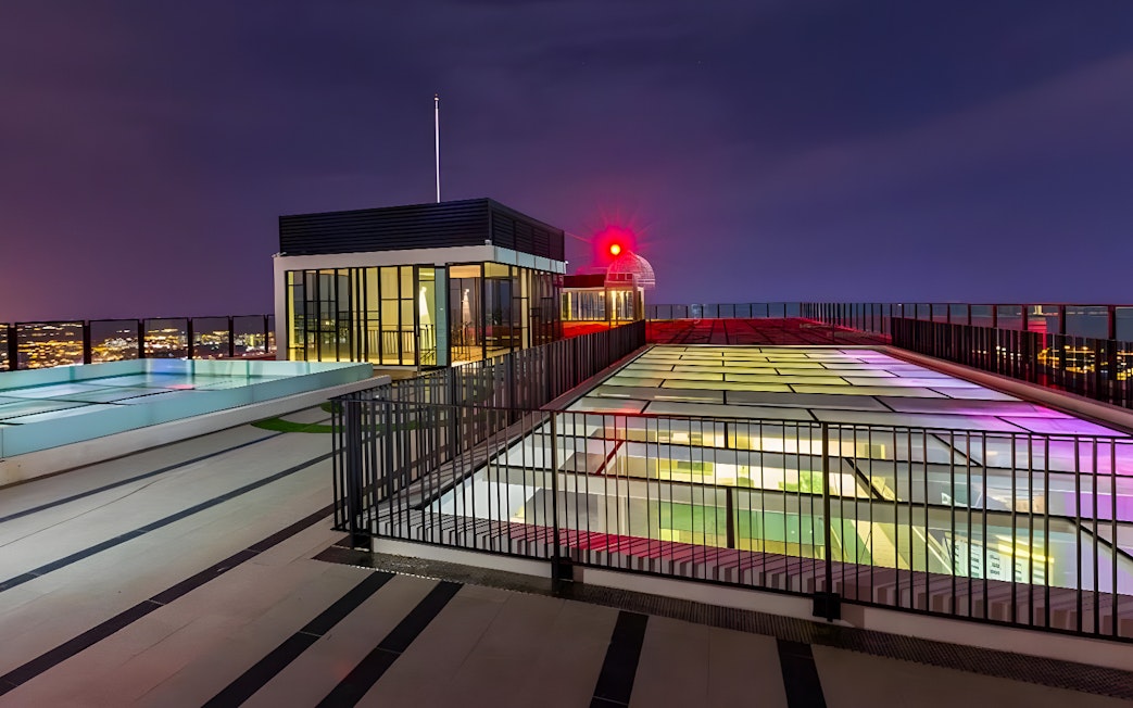 Rooftop view from The Shore Sky Tower with city lights at night.