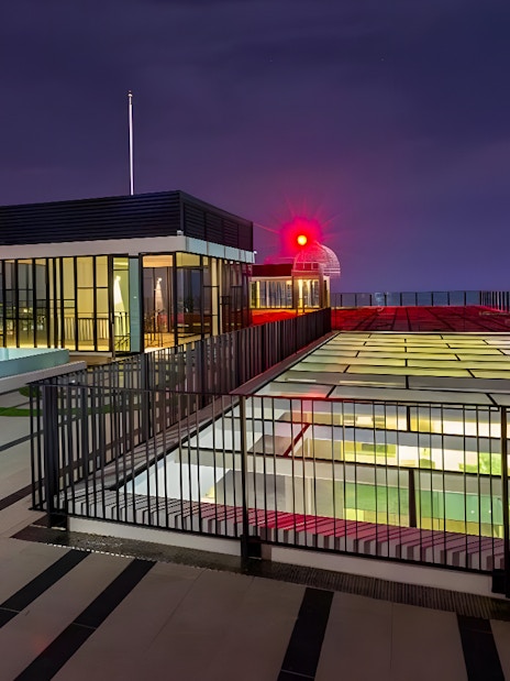 Rooftop view from The Shore Sky Tower with city lights at night.