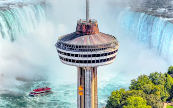 Skylon Tower observation deck overlooking Niagara Falls with a boat in the water below.
