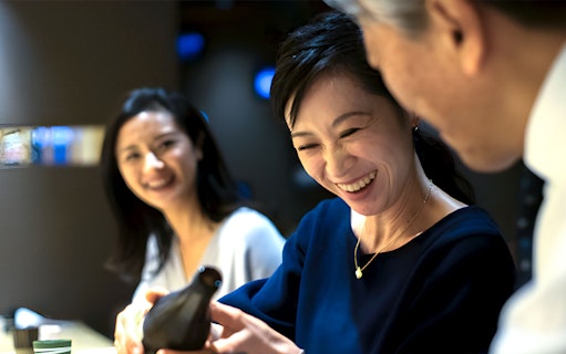 Guests enjoying a meal at Torafugu-tei Ginza, featuring puffer fish hot pot.