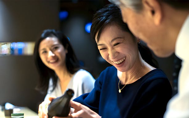 Guests enjoying a meal at Torafugu-tei Ginza, featuring puffer fish hot pot.