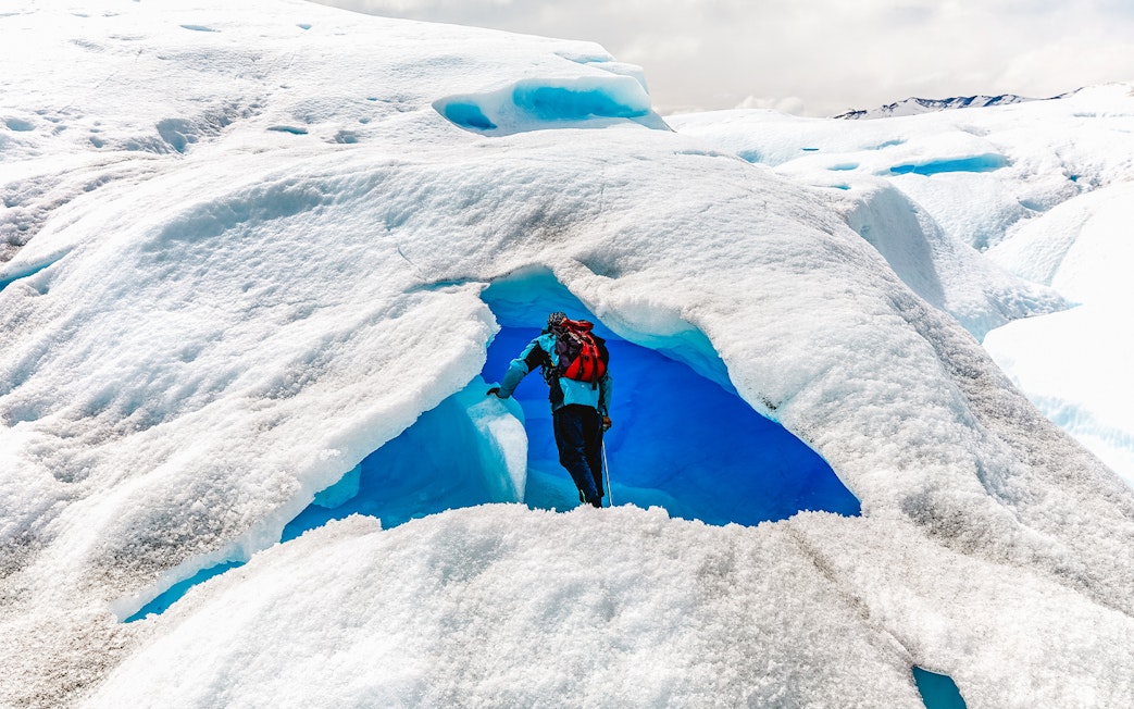 Tourist exploring ice cave at Big Ice, Perito Moreno Glacier, Argentina.