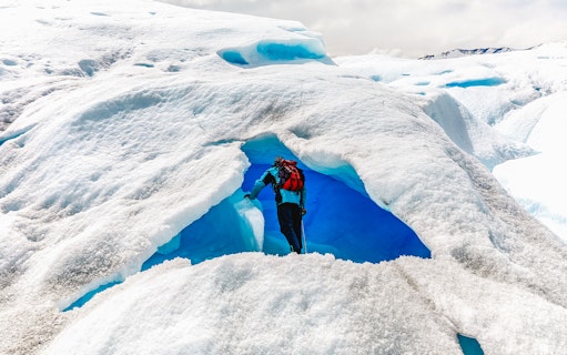 Tourist exploring ice cave at Big Ice, Perito Moreno Glacier, Argentina.