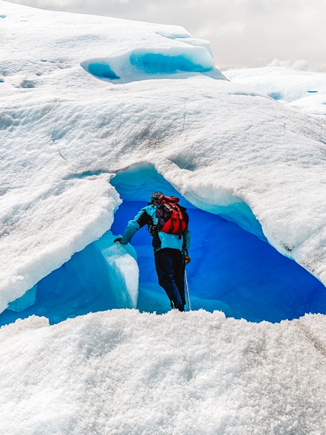 Tourist exploring ice cave at Big Ice, Perito Moreno Glacier, Argentina.