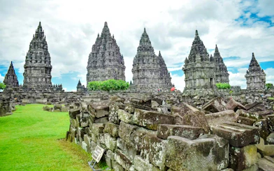 Prambanan Temple complex with ancient stone structures and green landscape in Yogyakarta, Indonesia.