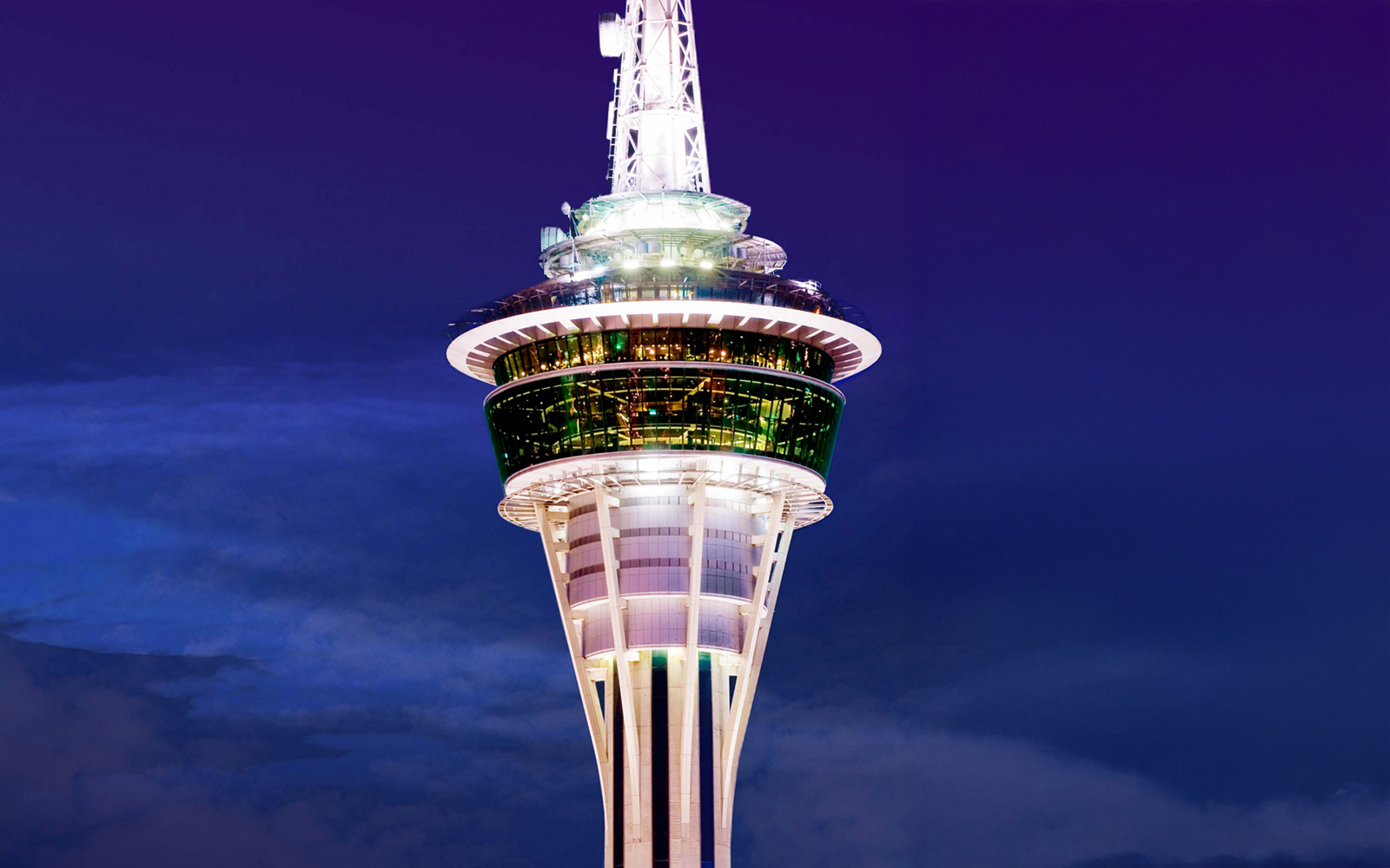 Close-up of Macau Tower against a twilight sky.
