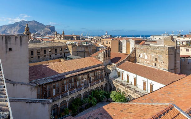 Palermo cityscape view from panoramic terrace with mountains and sea in the background.