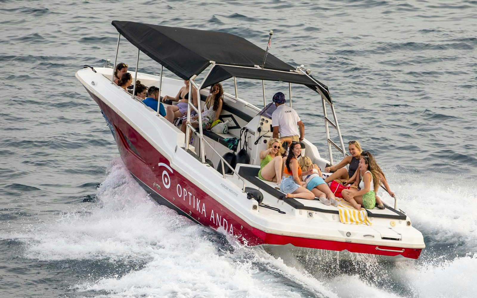 Boat with tourists enjoying island hopping near Trogir, Croatia.