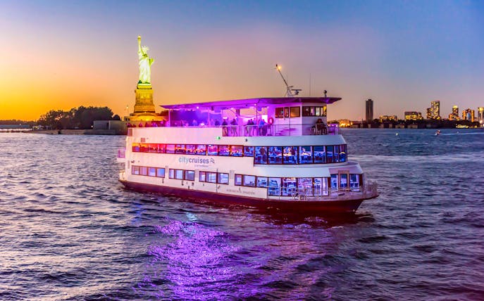 Cruise ship near Statue of Liberty during New York happy hour party cruise.