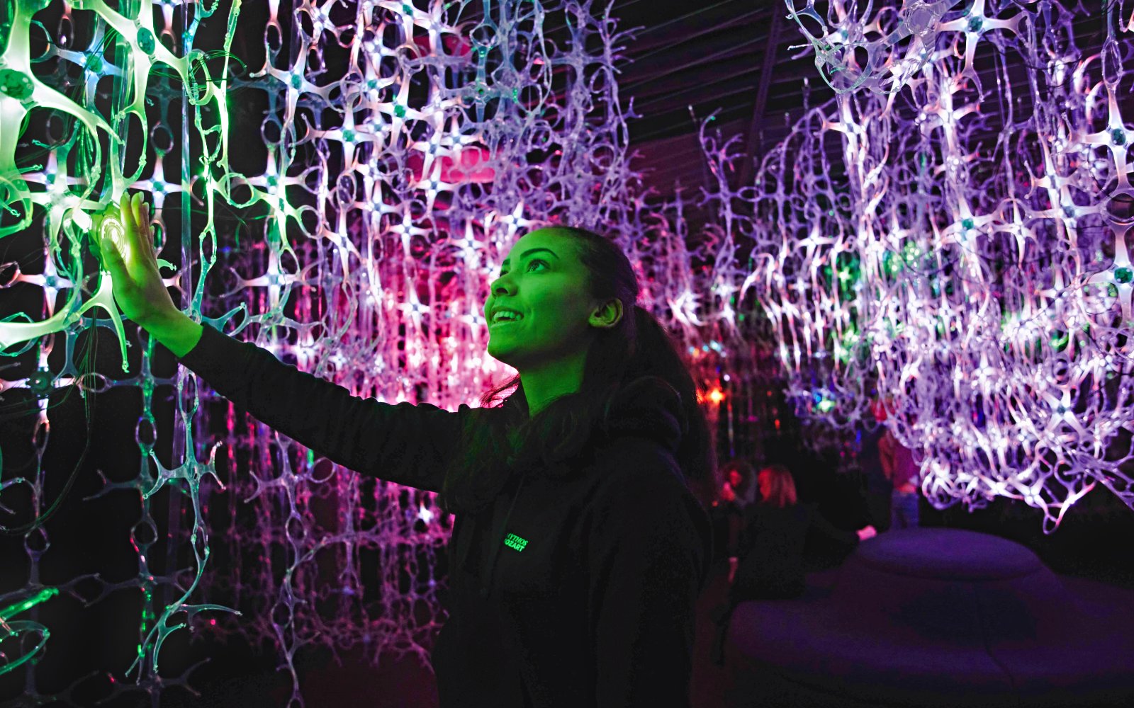 Guest interacts with light installation at Mythos Mozart Immersive Experience in Vienna.