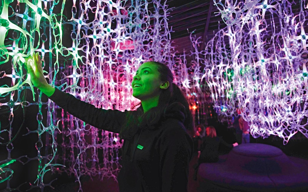 Guest interacts with light installation at Mythos Mozart Immersive Experience in Vienna.