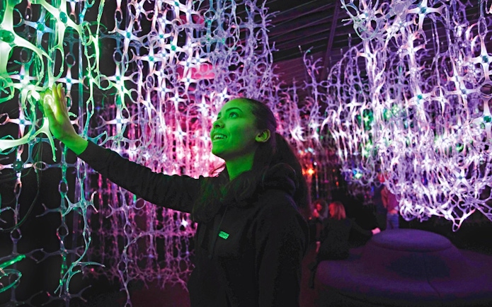 Guest interacts with light installation at Mythos Mozart Immersive Experience in Vienna.