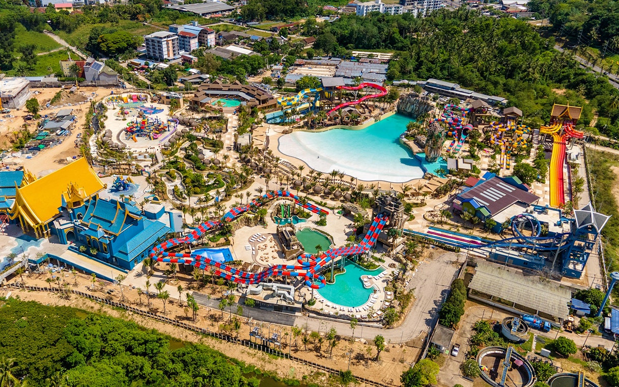 Aerial view of Andamanda Phuket water park with pools, slides, and themed buildings.