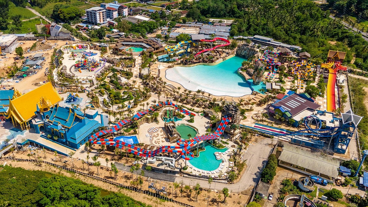 Aerial view of Andamanda Phuket water park with pools, slides, and themed buildings.