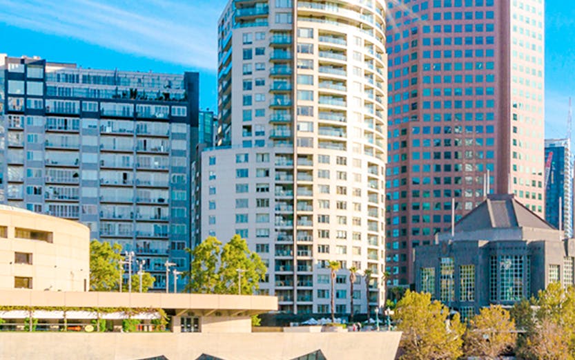 Cruise boat on Yarra River with Melbourne city skyline in the background.
