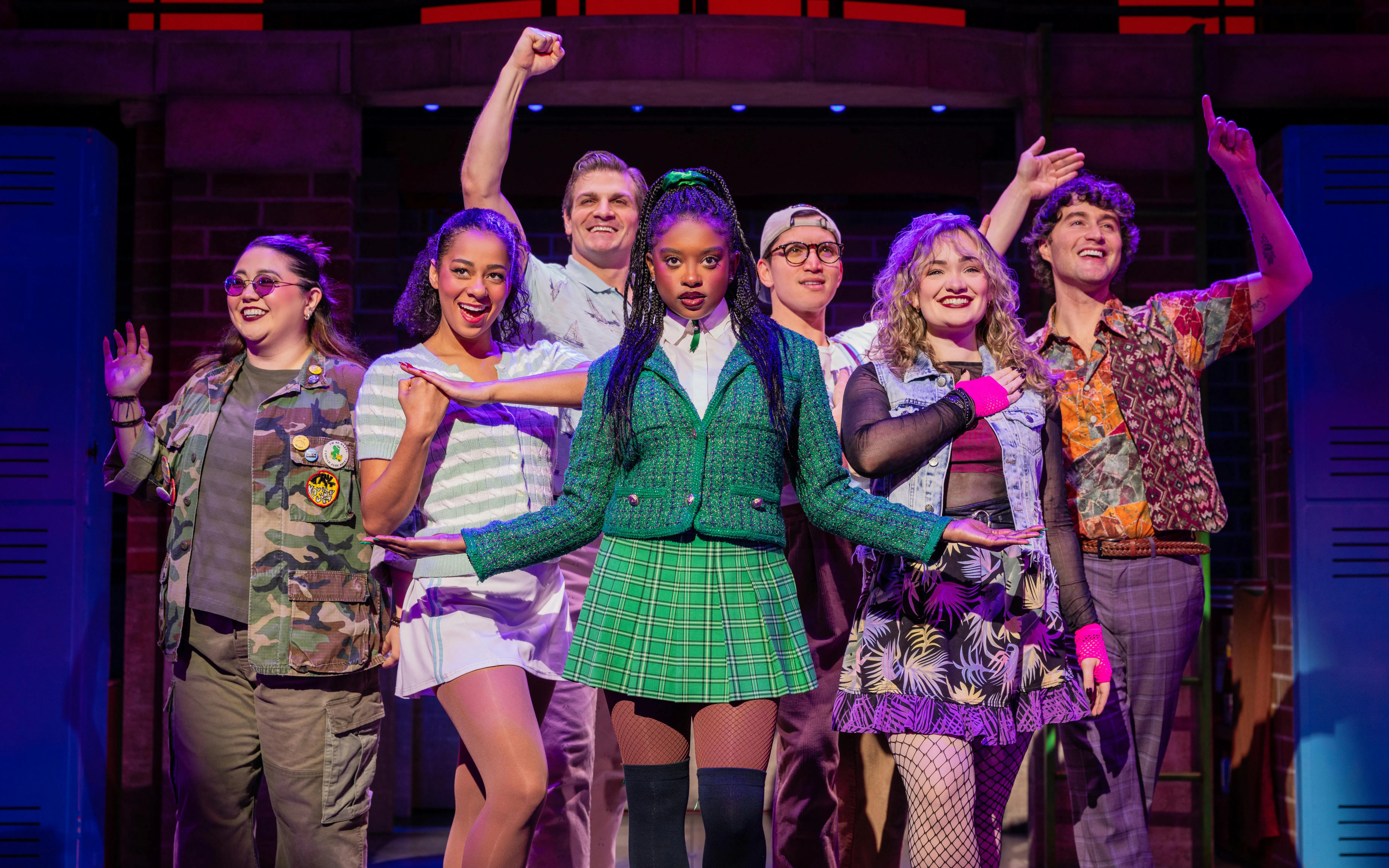 Cast of Heathers The Musical performing on stage with colorful costumes.