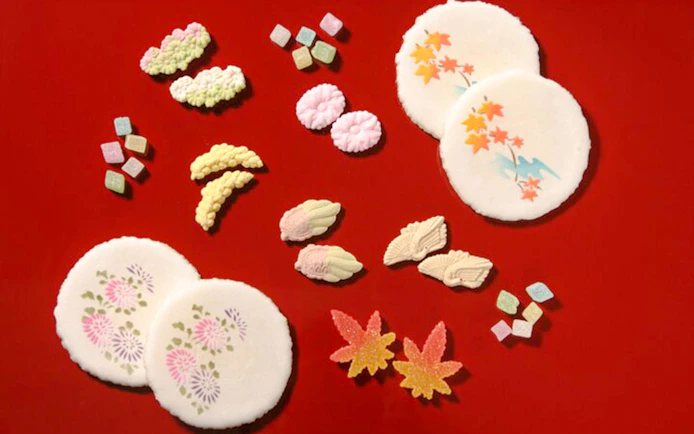 Traditional Japanese sweets on red background for Tokyo Matcha & Kimono Experience.