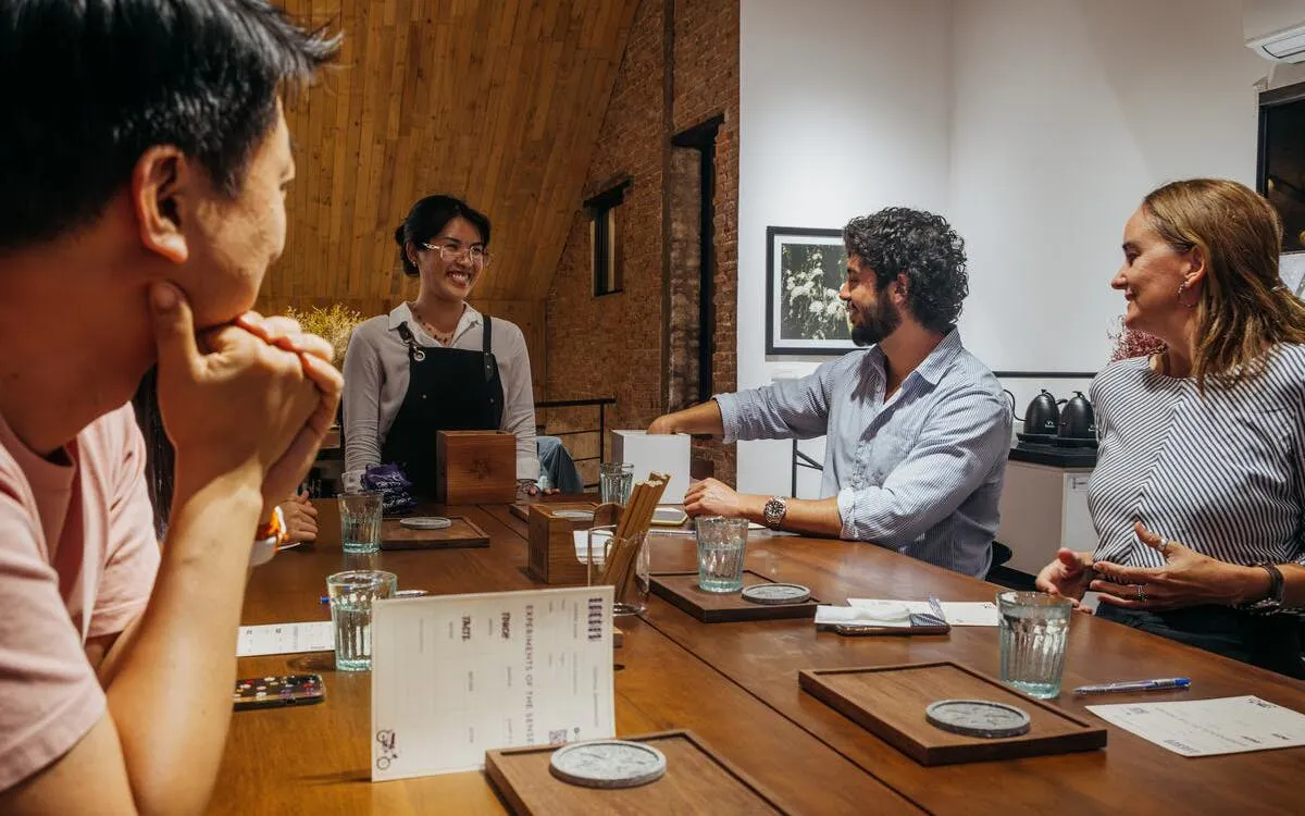 Group enjoying coffee-themed cocktails workshop in Vietnam.