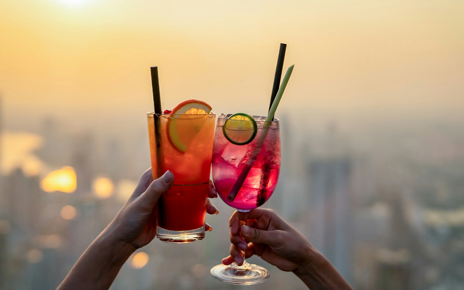 Cocktails at Melbourne skydeck bar with city skyline in the background.