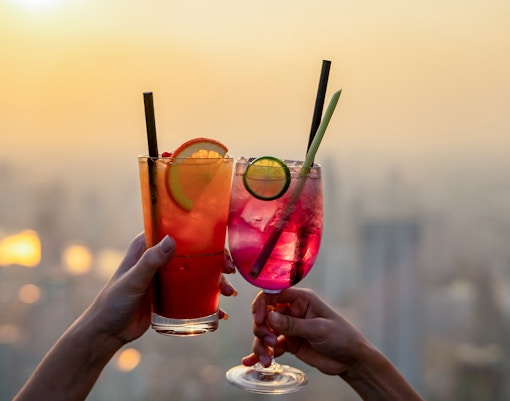 Bar patrons enjoying cocktails with a view of the Melbourne skyline from the Melbourne Skydeck.