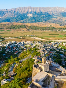 Aerial view of Gjirokastër, Albania, featuring the historic castle and surrounding landscape.