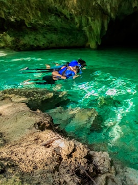 Snorkelers exploring a cenote in Cancun, Mexico.
