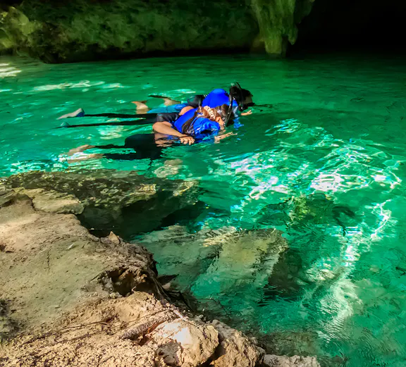 Snorkelers exploring a cenote in Cancun, Mexico.