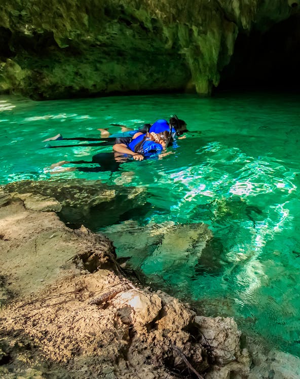 Snorkelers exploring a cenote in Cancun, Mexico.