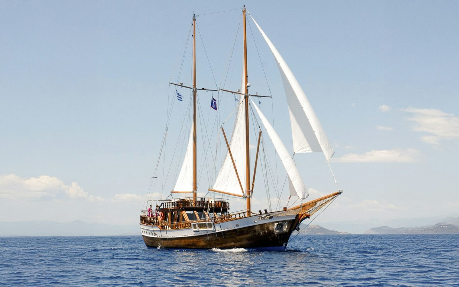 Gulet sailing in Saronic Gulf, Athens, Greece, showcasing traditional wooden vessel on half-day sea adventure.