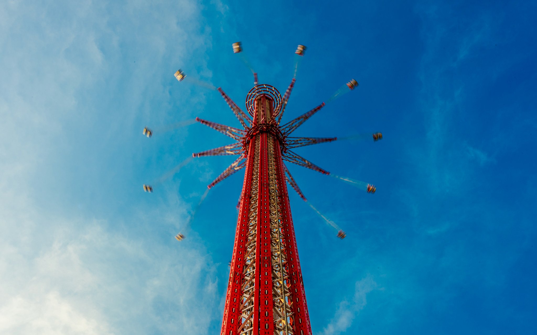 SkyFlyer ride spinning at Asiatique Bangkok against a clear blue sky.