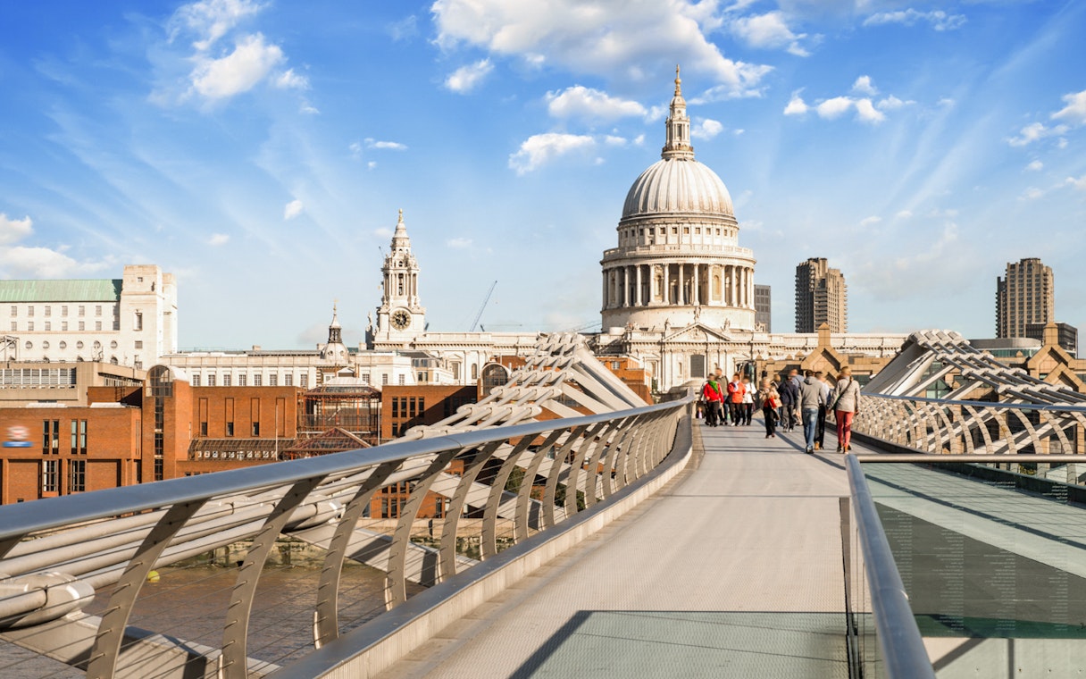 Millennium Bridge over River Thames with St. Paul's Cathedral in London.