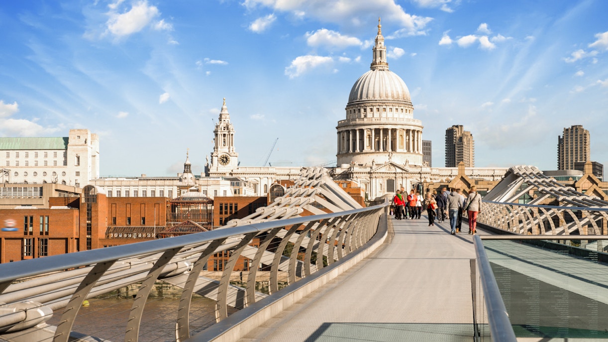Millennium Bridge over River Thames with St. Paul's Cathedral in London.