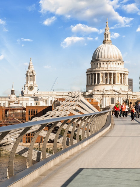 Millennium Bridge over River Thames with St. Paul's Cathedral in London.