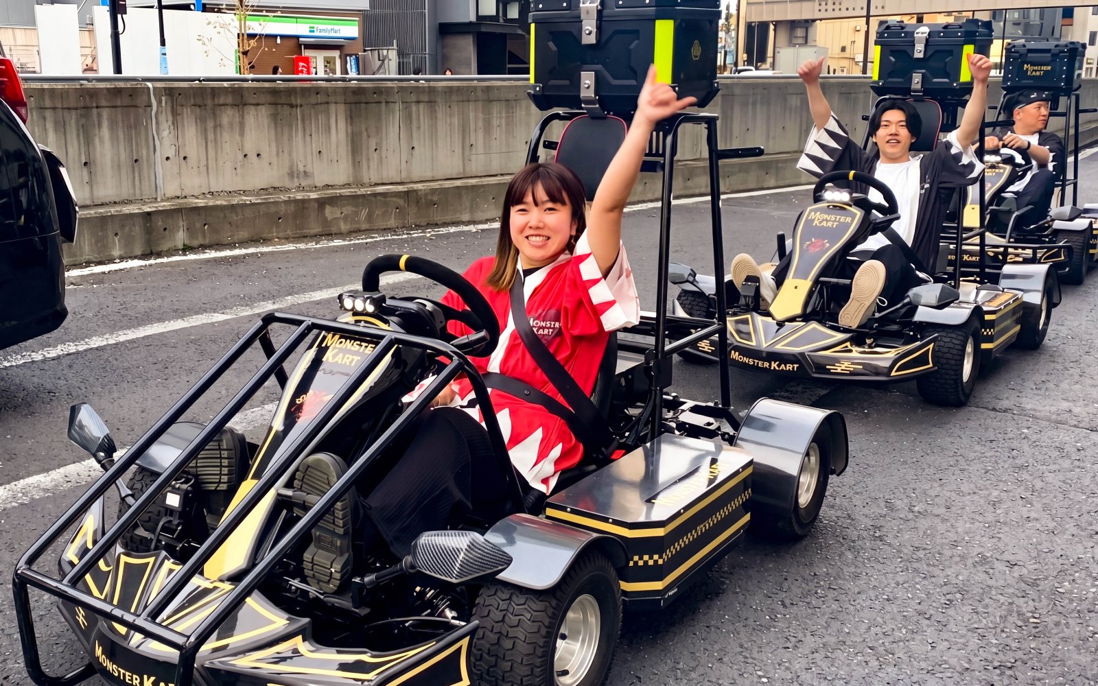 Participants enjoying a Street Kart experience in Tokyo, driving go-karts on city streets.