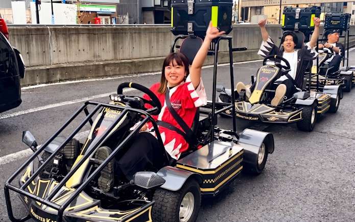 Participants enjoying a Street Kart experience in Tokyo, driving go-karts on city streets.